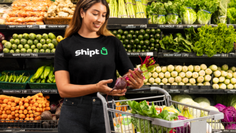 A Shipt employee picks produce for an order.